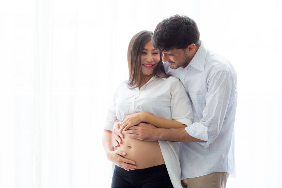 Pregnant Mother and Father Embracing 