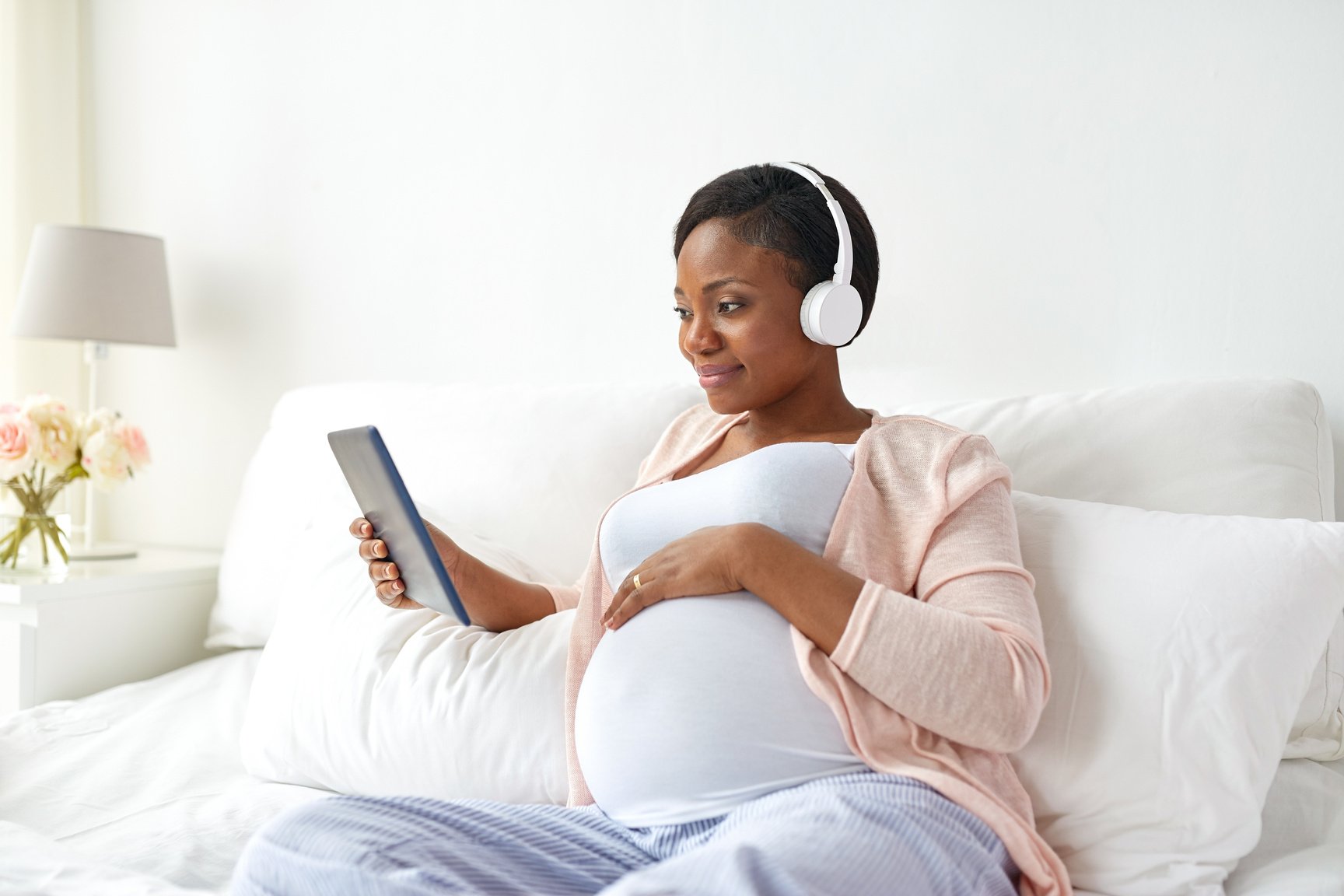 Pregnant Woman Listening to Music with Headphones